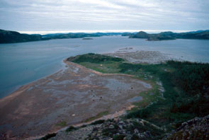 The delta of Nutakuanan-shipu taken from the top of the hill west of the delta. View to the east with Okpatik Island on the far right. Numerous 19th and early 20th century raised earthern tent-rings have been found by archaeologists on the peninsula near 